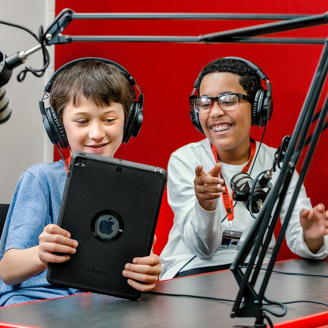 Kids in a recording studio using a tablet