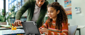 Teacher showing student something on a tablet