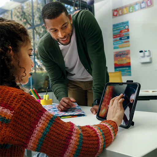 Home_Page_Screen_Protection Child and teacher looking at a tablet